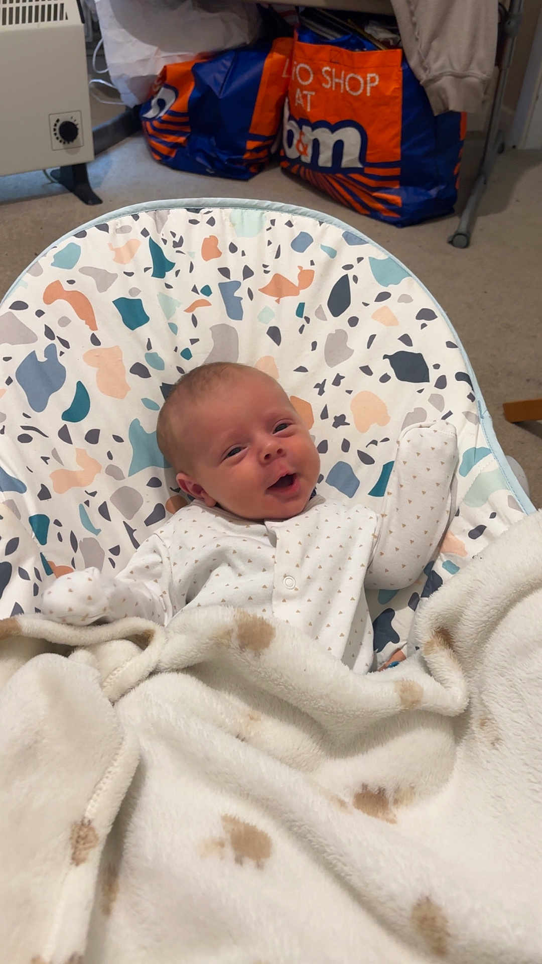 Noah joined the competition — help win amazing prizes! baby, infant, blanket, baby_chair, smiling, happy, face, cozy, patterned, clothing, indoor, carpet, furniture, bag, home, child, cute, newborn, relaxed, portrait