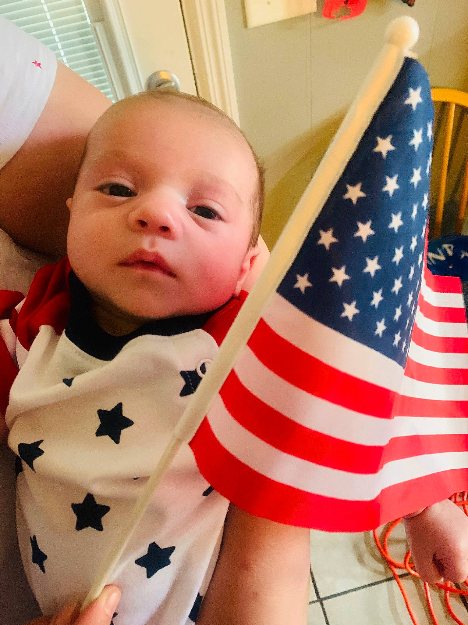Francis is registered to the contest to win money with this photo: baby, child, flag, flag_of_the_united_states, person, toddler