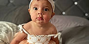 Olive joined the competition — help win amazing prizes! baby, child, infant, dress, headband, bed, pillow, blanket, face, eyes, foot, hand, cute, indoors, portrait, sitting, skin, fabric, headwear, furniture