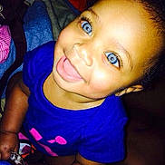 Aurora is registered to the contest to win money with this photo: baby, blue_eyes, smiling, child, infant, portrait, clothing, blue_shirt, happy, cute, skin, face, indoors, blanket, toddler, person, closeup, expression, warm, sitting
