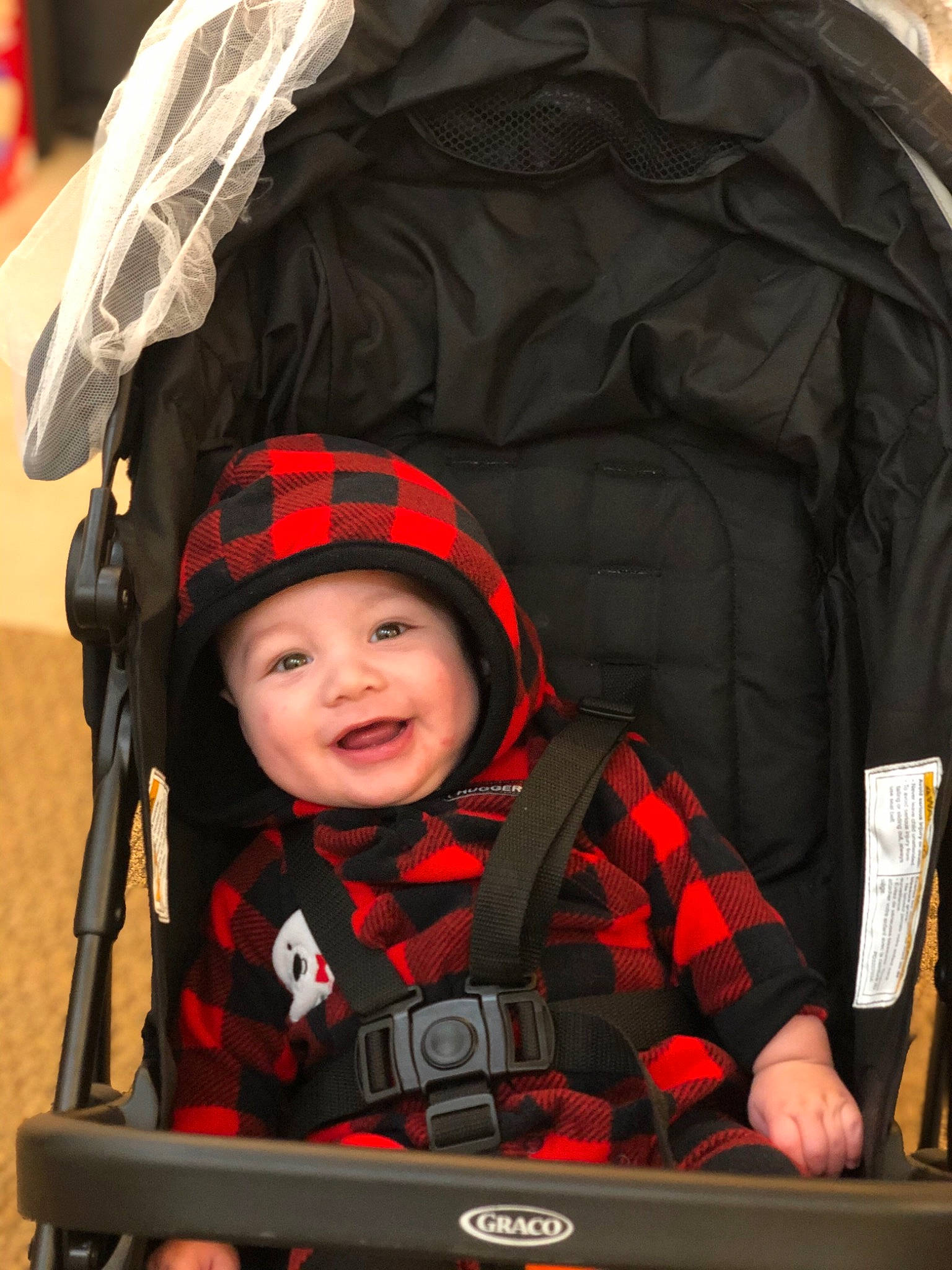 Kyzer joined the competition — help win amazing prizes! automotive_tire, baby, baby_carriage, baby_products, black, child, happy, headwear, jacket, orange, outerwear, person, personal_protective_equipment, photograph, product, red, smile, snapshot, tire, toddler