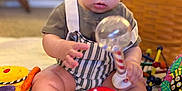 Matthew joined the competition — help win amazing prizes! baby, child, toy, rattle, blanket, indoor, cute, sitting, playtime, infant, colorful, focus, soft_light, striped_clothing, feet, hands, face, expression, homedecor, carpet