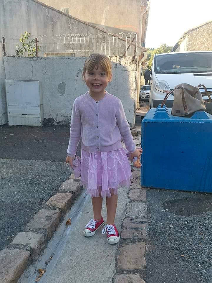 Maëline a rejoint le concours — aidez-le/la à gagner de superbes lots ! asphalt, automotive_exterior, car, family_car, joy, leisure, magenta, motor_vehicle, pattern, person, pink, road, road_surface, sidewalk, sky, street, summer, toddler, travel, truck