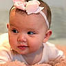 Megan joined the competition — help win amazing prizes! baby, infant, headband, pink, bow, face, cheeks, eyes, skin, portrait, closeup, soft_lighting, blanket, fluffy, cute, child, person, indoors, expression, resting