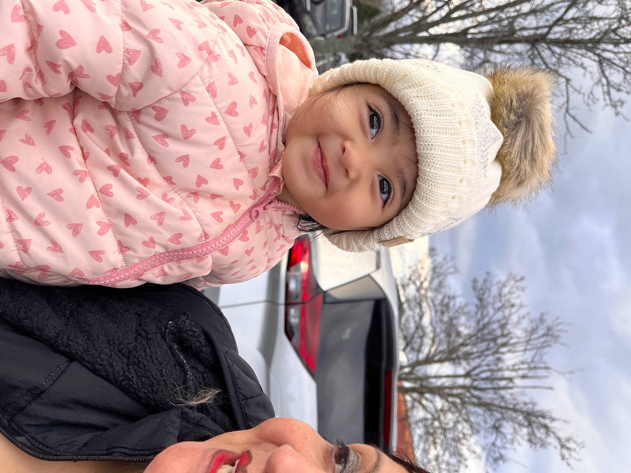 Catalina is registered to the contest to win money with this photo: baby, child, event, freezing, fur, grass, happy, hat, headwear, human_body, joy, leisure, outerwear, pattern, people_in_nature, person, plant, playing_in_the_snow, sleeve, snow