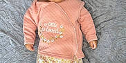 Zelestia is registered to the contest to win money with this photo: baby, infant, headband, pink_clothing, floral_pants, blanket, lying_down, indoors, cute, child, portrait, sleepwear, cozy, soft_texture, newborn, small_hands, footed_pants, expressionless, comfortable, bedspread
