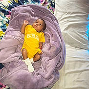 Zelestia joined the competition — help win amazing prizes! baby, infant, blanket, yellow_onesie, bed, pillow, floral_pattern, purple_blanket, lying_down, indoors, soft_texture, cute, child, person, sleepwear, resting, skin, face, head, footwear
