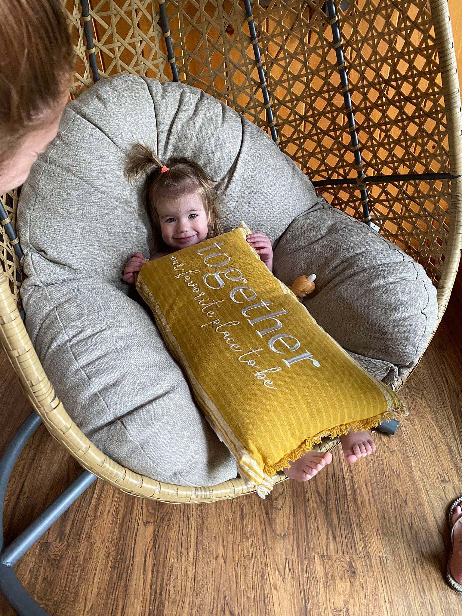 Laken is registered to the contest to win money with this photo: brown, chair, child, comfort, couch, facial_expression, flooring, font, grass, hardwood, joy, mammal, mesh, person, product, publication, room, sitting, swing, textile