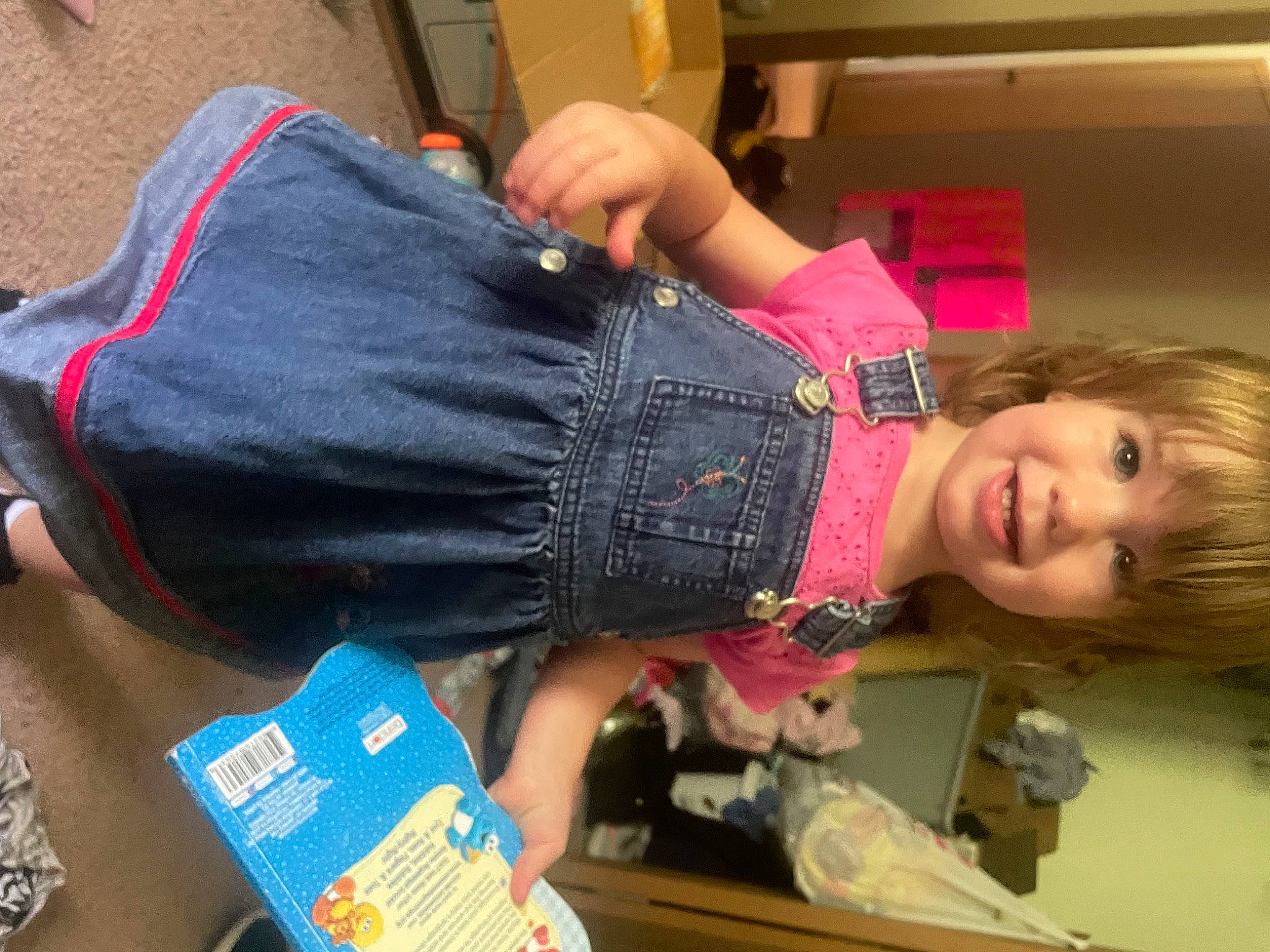 Laken is registered to the contest to win money with this photo: abdomen, child, denim, elbow, finger, fun, human_leg, joint, joy, knee, nail, pattern, person, room, sitting, smile, thigh, thumb, toddler, waist