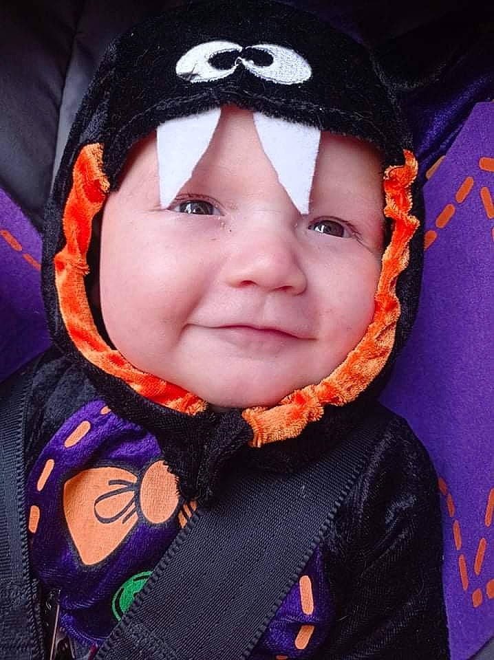 Logan participe au concours pour gagner de l'argent avec cette photo : baby, baby_toddler_clothing, cheek, chin, cool, flash_photography, happy, headgear, headwear, human, iris, lip, nose, outerwear, people, person, pink, product, purple, smile
