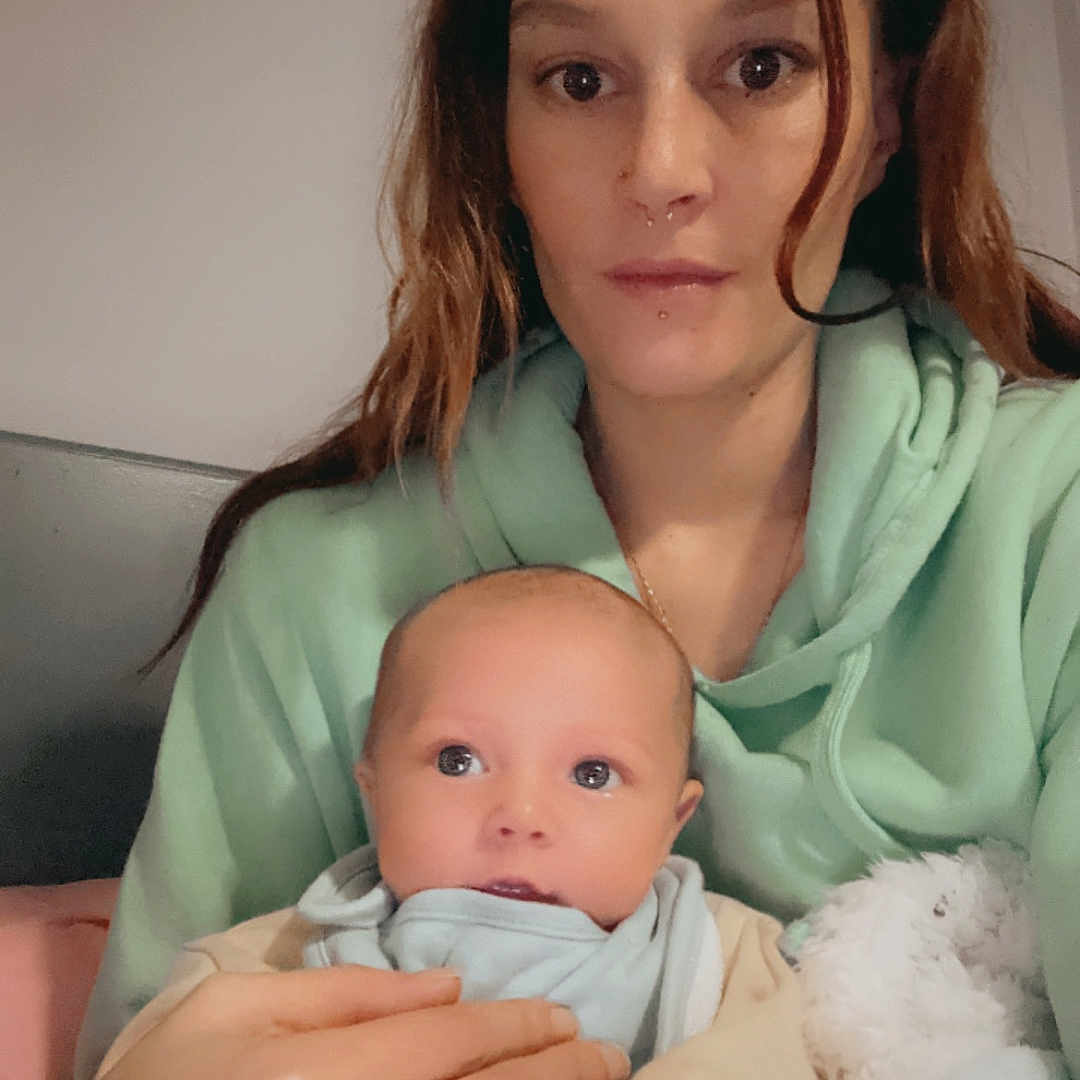 Arlo-Jaxx is registered to the contest to win money with this photo: adult, baby, blanket, bodypart, clothing, couch, face, female, finger, furniture, hand, happy, head, newborn, people, person, photography, portrait, smile, woman