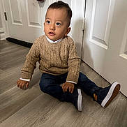 Theo joined the competition — help win amazing prizes! toddler, child, sitting, indoor, floor, door, sweater, jeans, shoes, umbrella, curious, young_child, casual_clothing, wooden_floor, white_door, portrait, person, cute, indoors, young_kid
