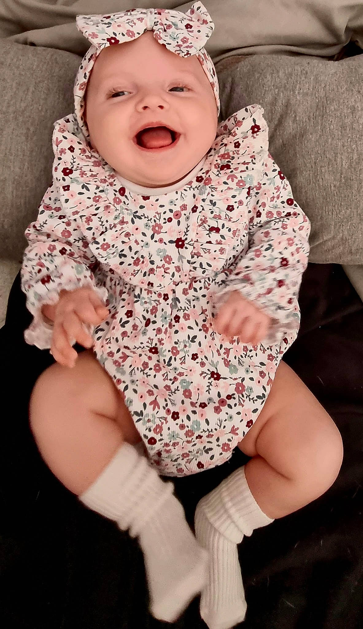 Ariella joined the competition — help win amazing prizes! arm, baby, baby_toddler_clothing, black, comfort, dress, eye, face, facial_expression, gesture, happy, head, headgear, headwear, lip, mouth, neck, person, skin, sleeve