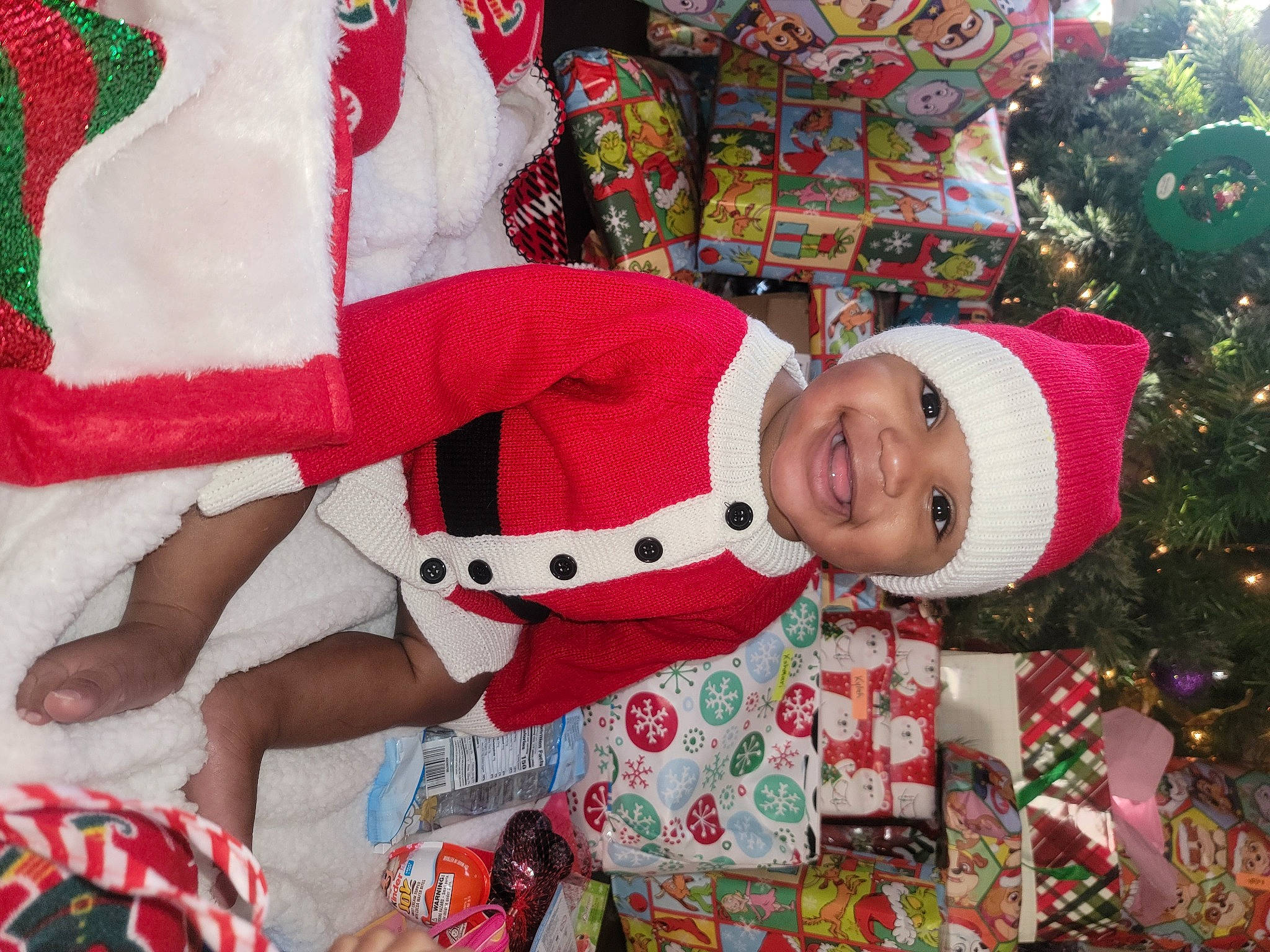 Kahmari joined the competition — help win amazing prizes! baby_toddler_clothing, child, christmas, christmas_eve, christmas_tree, creative_arts, event, face, green, happy, head, headwear, holiday, human_body, joy, lap, pattern, person, red, sleeve