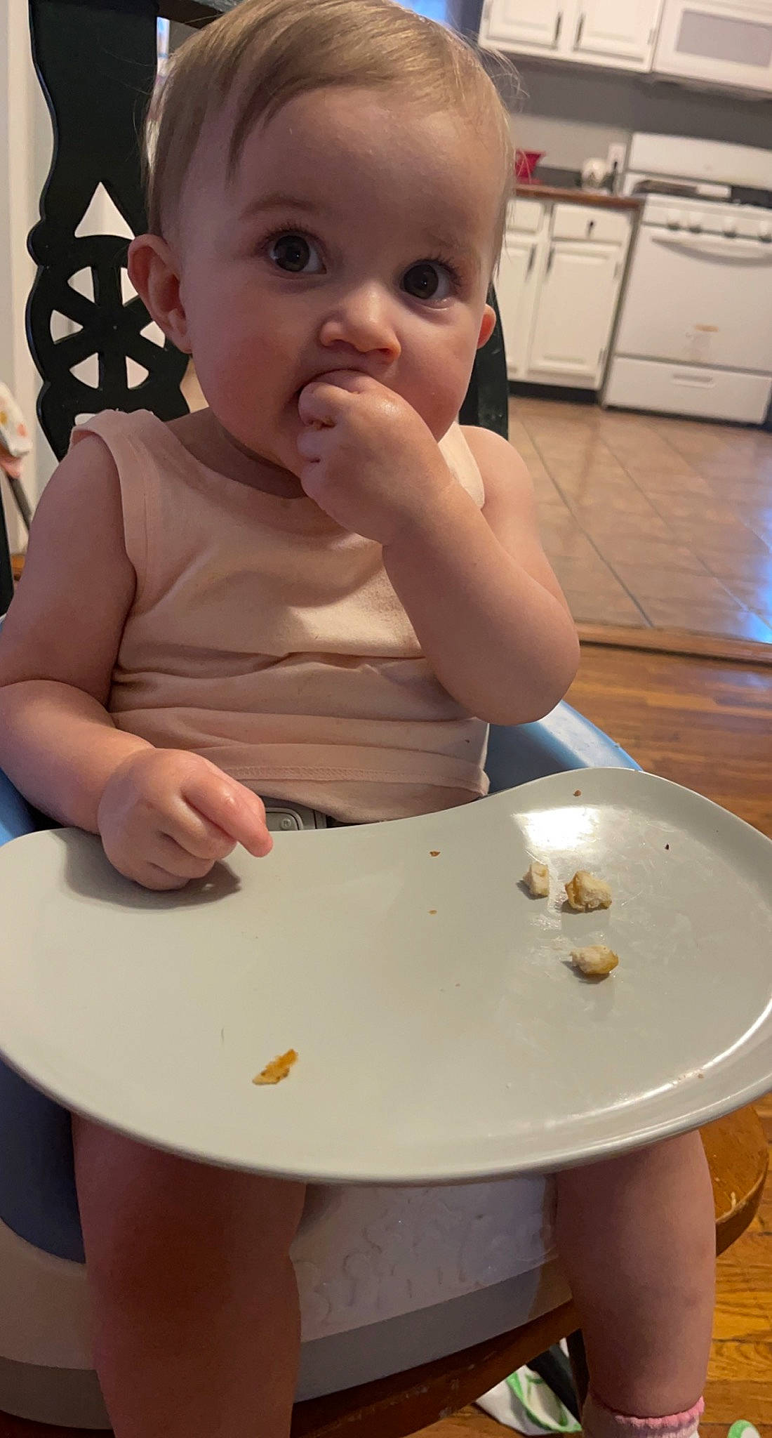 Stella is registered to the contest to win money with this photo: baby, baby_toddler_clothing, cabinetry, cheek, dishware, drinkware, eye, face, finger, food, food_craving, head, lip, person, plate, serveware, skin, table, tableware, toddler