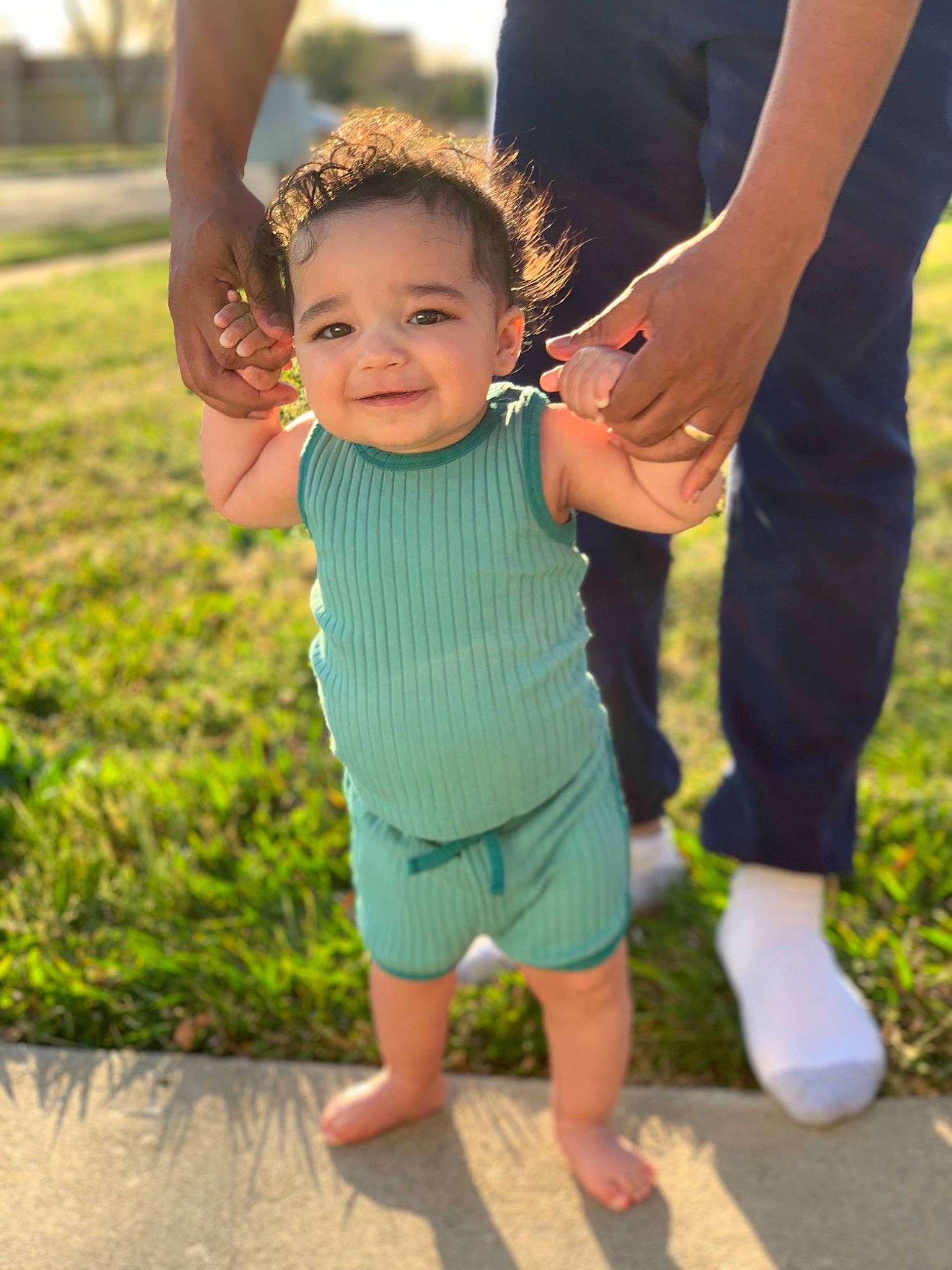 Crew is registered to the contest to win money with this photo: baby, barefoot, child, event, foot, fun, gesture, grass, happy, holding_hands, human_leg, joint, joy, lawn, leg, leisure, people_in_nature, person, recreation, smile