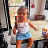 Alanii joined the competition — help win amazing prizes! child, toddler, baby, sitting, portrait, indoor, restaurant, table, stroller, denim_skirt, white_top, necklace, bracelets, sneakers, snack, fire_alarm, window, chair, tile_floor, fashion