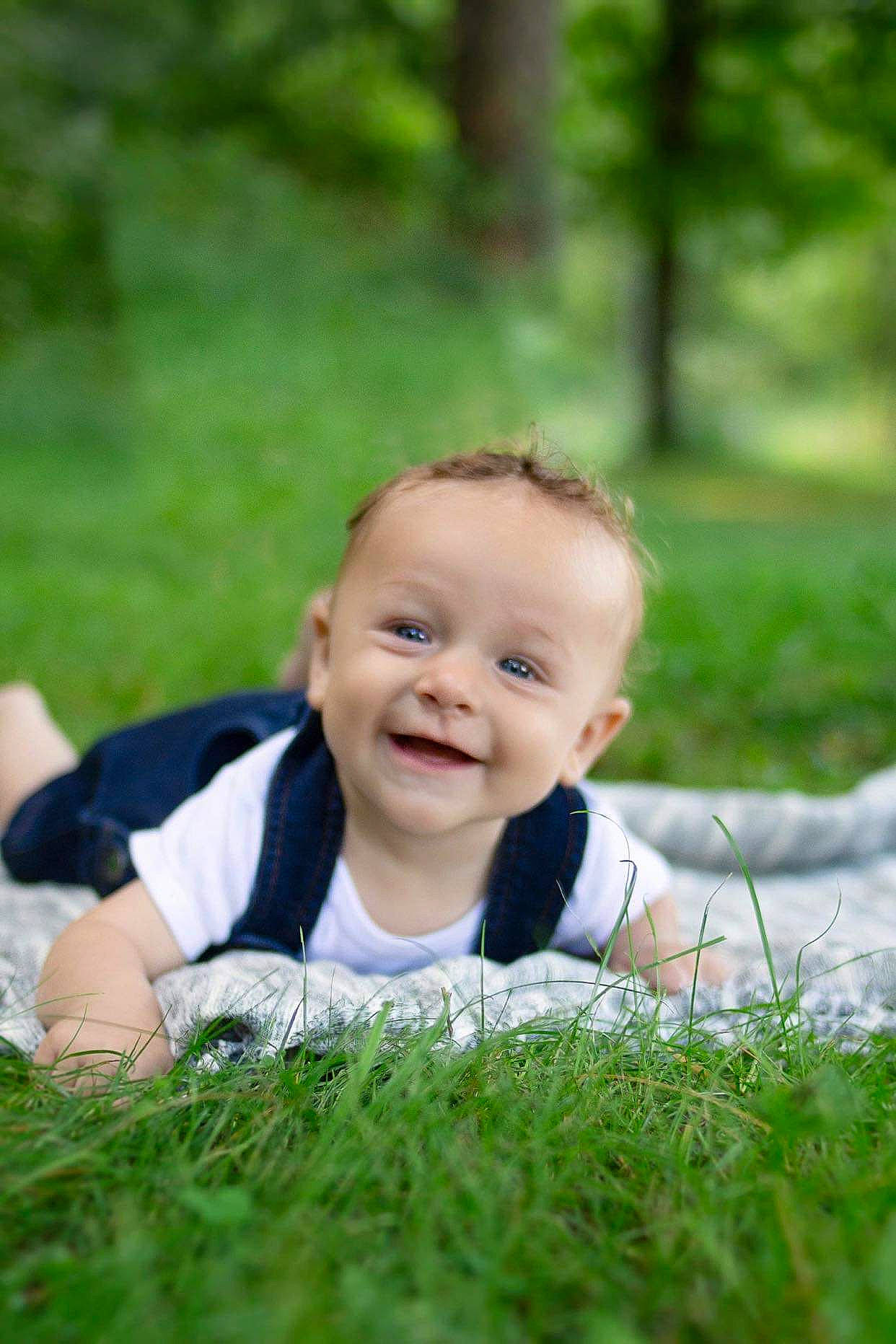 Braxton is registered to the contest to win money with this photo: baby, child, grass, grass_family, happy, joy, lawn, leisure, meadow, people_in_nature, person, photograph, photography, plant, portrait, portrait_photography, sitting, smile, summer, toddler