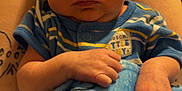 Jamison joined the competition — help win amazing prizes! baby, blanket, blue_blanket, comfort, cozy, cute, face, hand, human, indoors, infant, lap, newborn, person, portrait, resting, skin, sleepy, striped_clothing, young_child