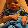 Jamison joined the competition — help win amazing prizes! baby, infant, blue_blanket, striped_clothing, person, hand, lap, skin, face, newborn, indoors, resting, blanket, cozy, portrait, human, cute, young_child, sleepy, comfort