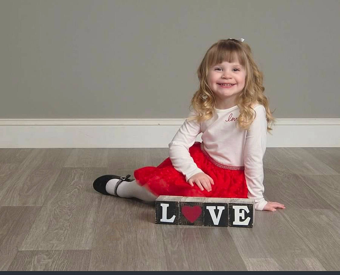 Audreianna joined the competition — help win amazing prizes! baby_toddler_clothing, blond, flash_photography, floor, flooring, fun, happy, hardwood, human_leg, joy, knee, magenta, pattern, person, sitting, sleeve, smile, sportswear, t_shirt, thigh