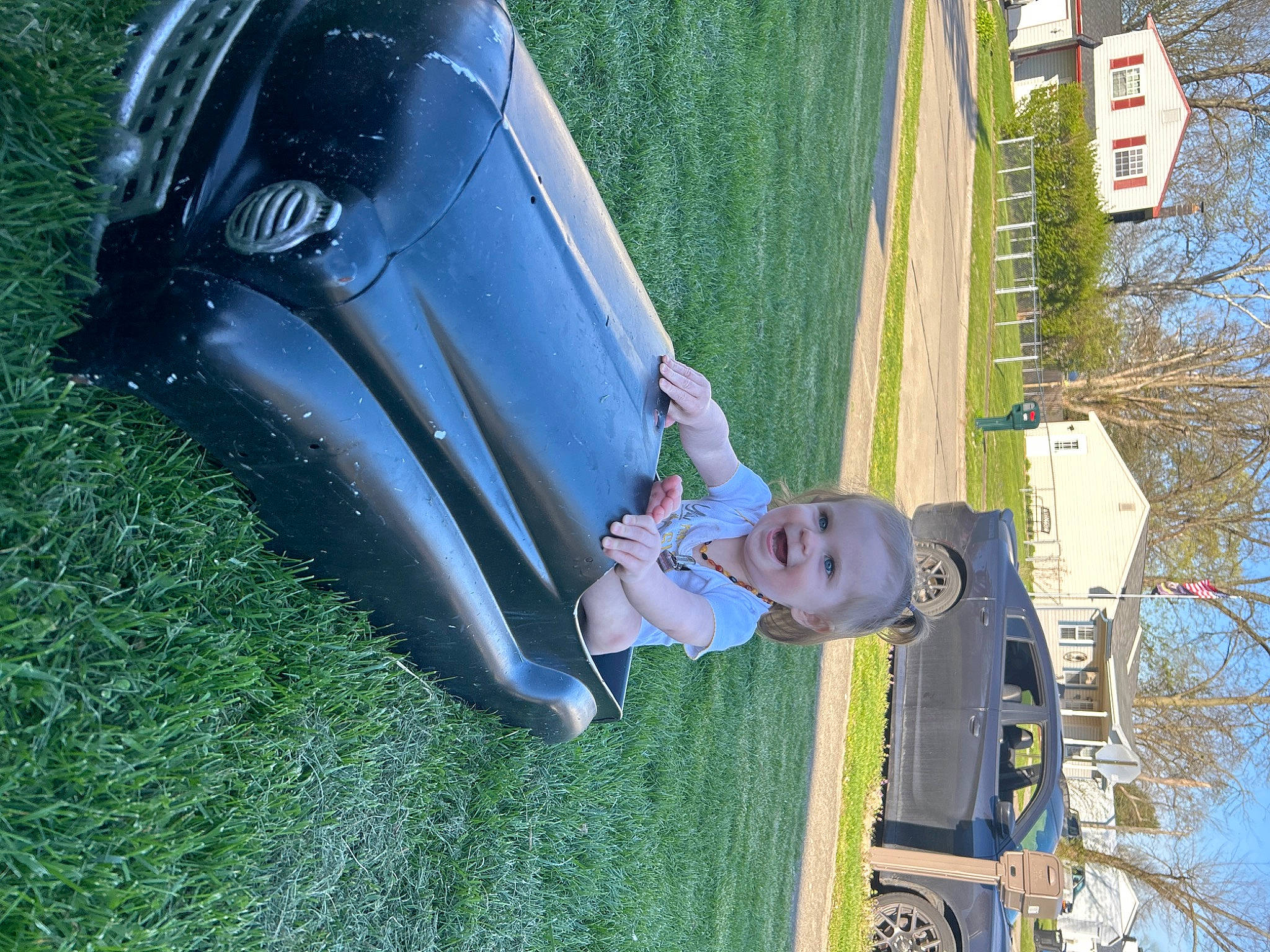 Charlotte joined the competition — help win amazing prizes! automotive_design, automotive_exterior, automotive_lighting, automotive_tire, bumper, car, fender, grass, green, hood, joy, leisure, line, motor_vehicle, person, plant, sky, smile, tree, vehicle