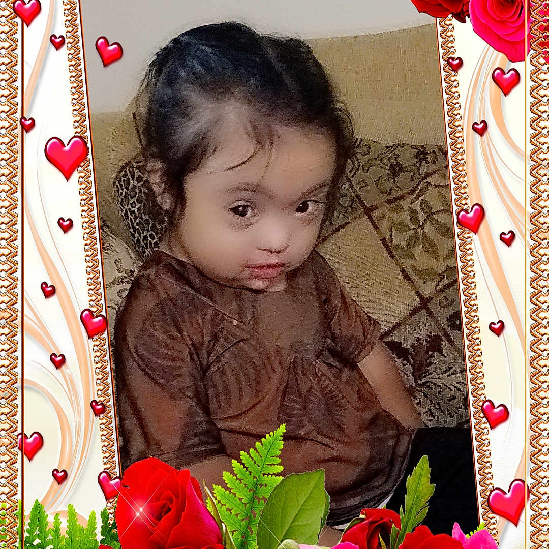Nala joined the competition — help win amazing prizes! child, girl, brown_clothing, couch, patterned_cushion, roses, red_hearts, digital_frame, portrait, indoor, decorative_border, flowers, sparkles, green_leaves, seated, young_child, cute, expression, love_theme, home_interior