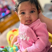 Raelynn is registered to the contest to win money with this photo: baby, big_eyes, blanket, bokeh, caregiver_hand, child, close_up, crib, cute, face, hair, hand, indoor, infant, looking_at_camera, pink_onesie, portrait, skin, soft_lighting, tongue_out
