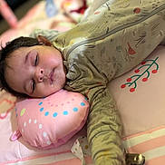 Raelynn joined the competition — help win amazing prizes! baby, infant, sleeping_baby, drool, pillow, play_mat, onesie, arm, face, hair, eyelids, zipper, patterned_clothing, bedding, pink, closeup, portrait, peaceful, indoors, nursery