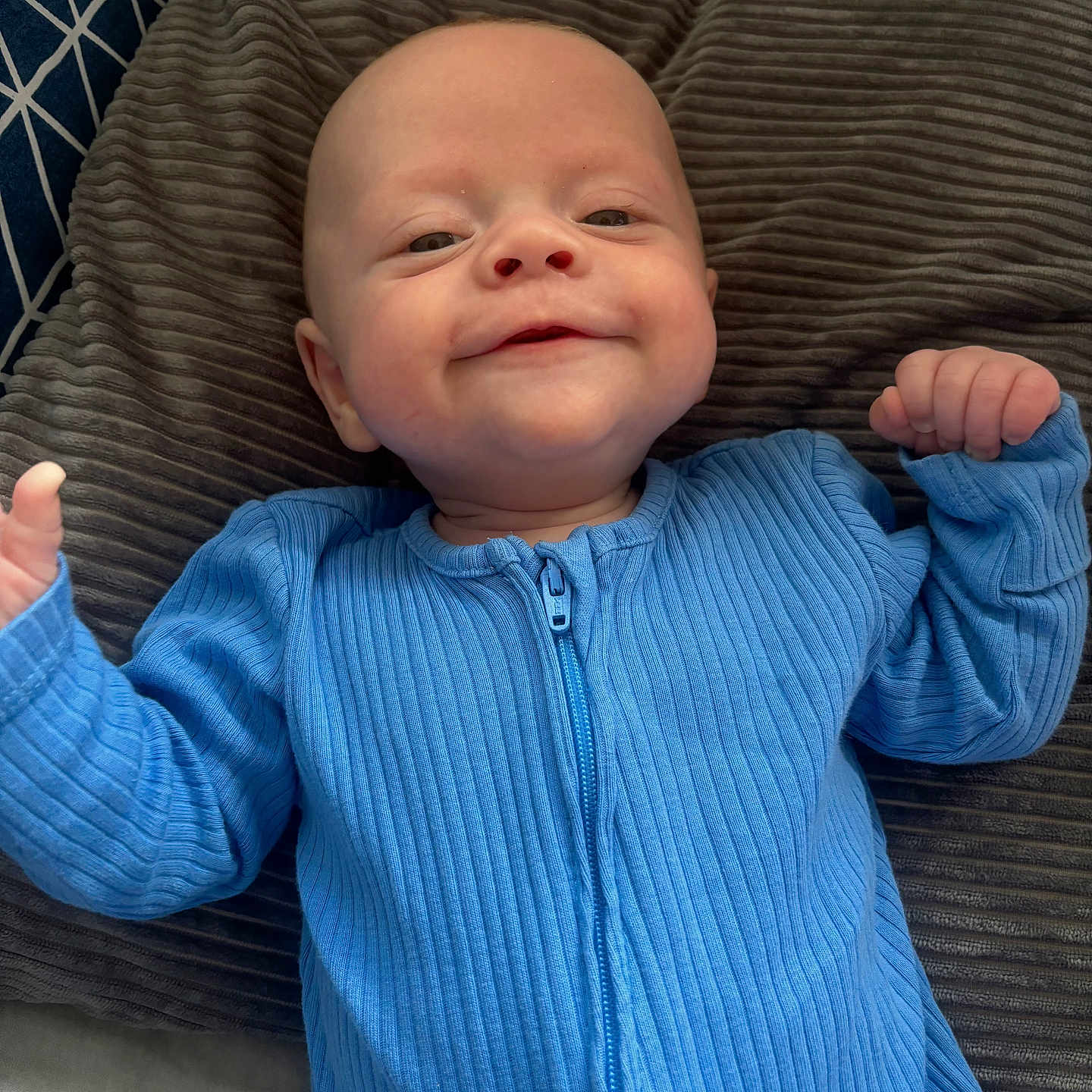Finley joined the competition — help win amazing prizes! baby, bodypart, clothing, couch, cushion, face, finger, furniture, hand, happy, head, homedecor, knitwear, newborn, pants, person, photography, portrait, smile, sweater