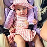 baby, child, car_seat, pink_dress, sunhat, pacifier, beads, purple_cushion, seat_belt, infant, cute, expression, indoor, person, sitting, clothing, soft_material, comfort, closeup, young