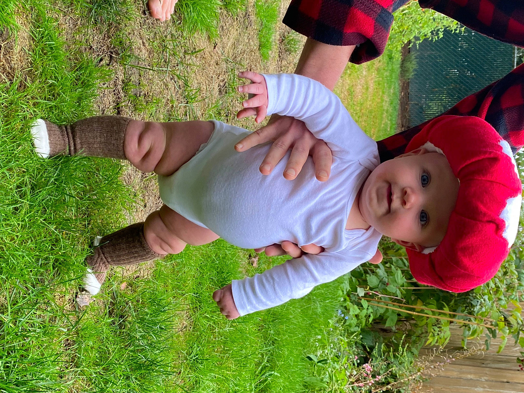Jericho is registered to the contest to win money with this photo: baby_toddler_clothing, child, fun, gesture, grass, grass_family, grassland, green, happy, hat, headwear, human_leg, knee, lawn, leisure, meadow, people_in_nature, person, plant, shoe
