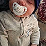 baby, sleeping, pacifier, hat, clothing, zipper, blanket, couch, pillow, floral, hand, face, infant, cute, cozy, indoors, child, peaceful, resting, wearing