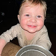 Kohen is registered to the contest to win money with this photo: child, toddler, baby, smile, red_eye, blond_hair, toothy_grin, metal_bucket, shirt, long_sleeves, hand, indoor, flash, closeup, portrait, playful, sticker, furniture, evening, cheeky