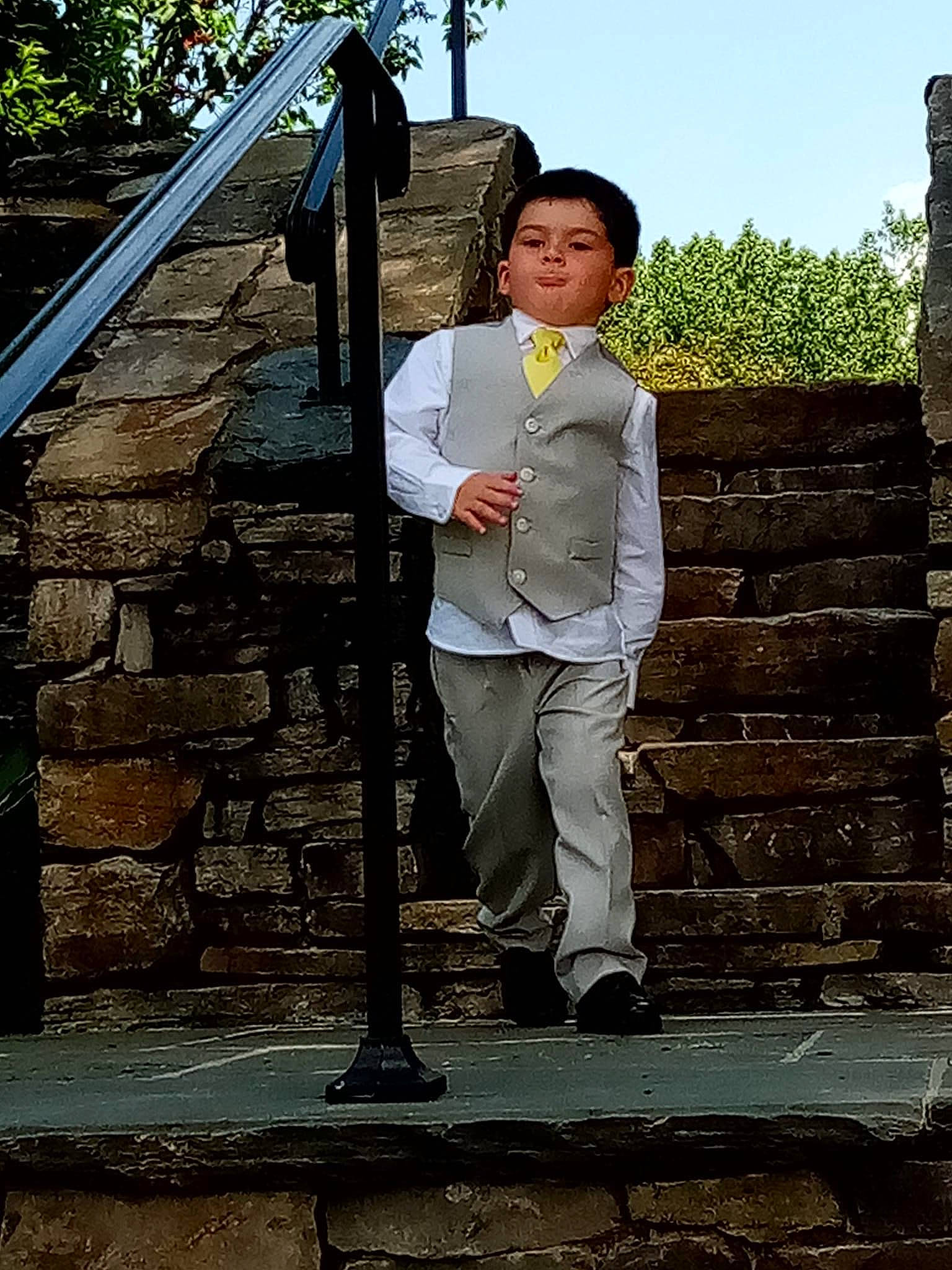 Anthony is registered to the contest to win money with this photo: brick, brickwork, concrete, denim, formal_wear, fun, grass, leisure, people_in_nature, person, roof, sky, stone_wall, tourism, tree, uniform, vacation, wood