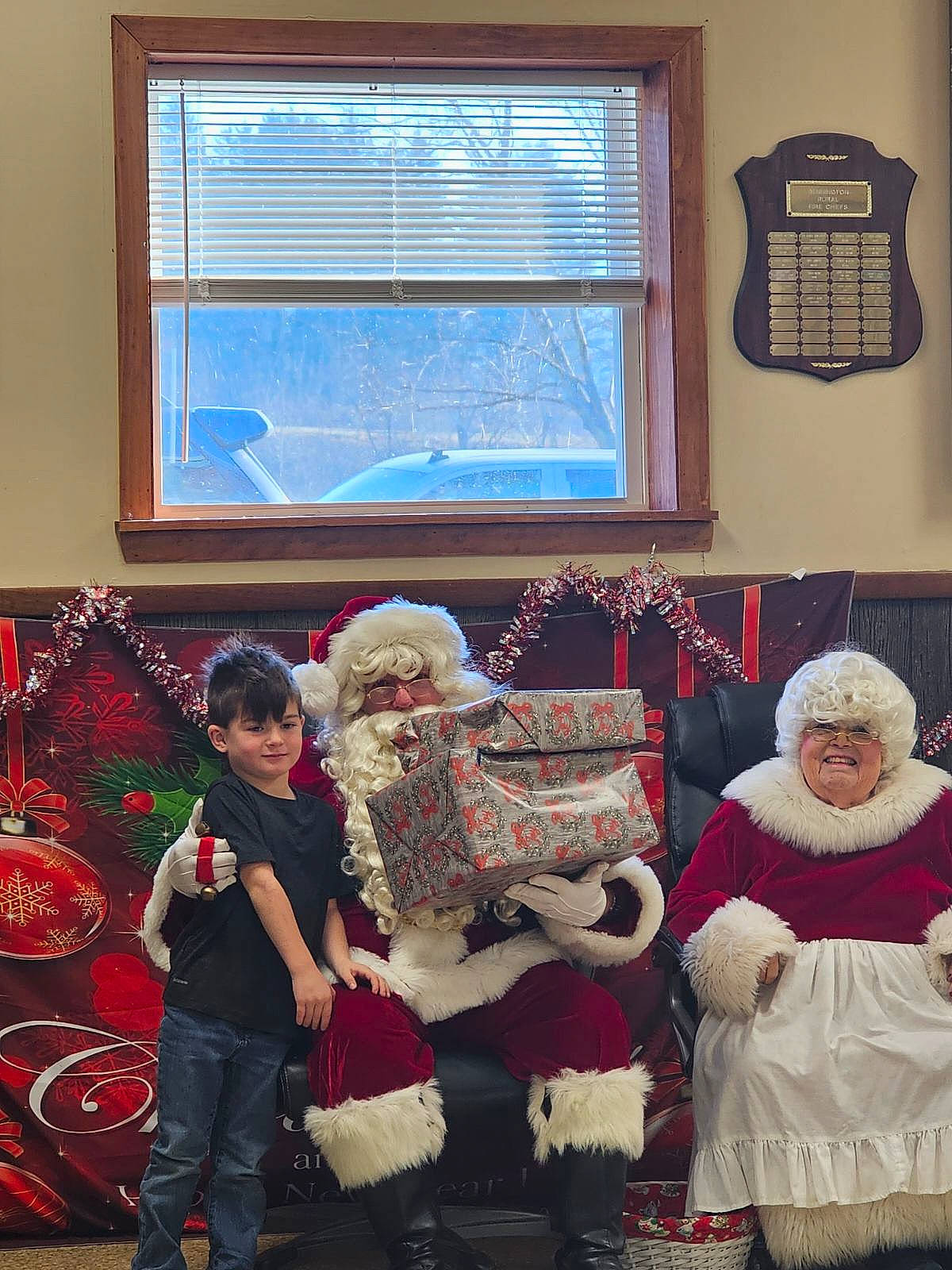 Anthony is registered to the contest to win money with this photo: boot, christmas, couch, event, fun, hat, headwear, holiday, interior_design, joy, lamp, lap, living_room, person, red, room, santa_claus, toddler, white, window