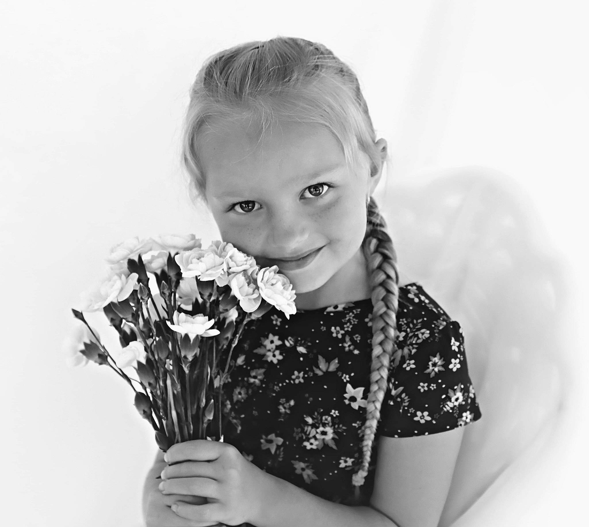 Miranda is registered to the contest to win money with this photo: black, black_and_white, eyelash, face, finger, flash_photography, flower, flower_arranging, gesture, hand, happy, human, human_body, iris, person, petal, plant, sleeve, standing, style
