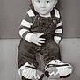 baby, child, sitting, striped_sweater, denim_overalls, shoes, floor, portrait, smile, indoor, cute, young_child, monochrome, casual_clothing, hand_gesture, face, person, young, happy, small