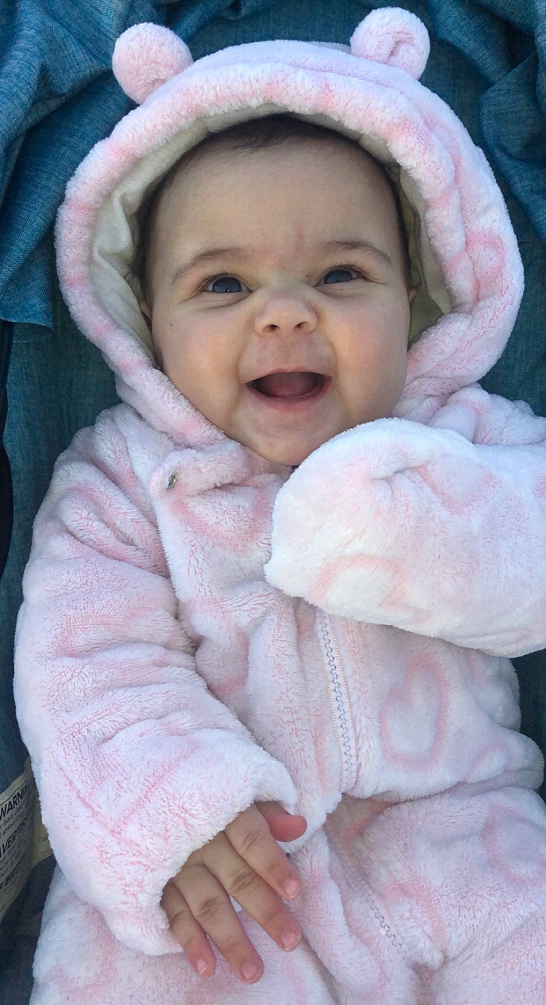 Harmony is registered to the contest to win money with this photo: baby, cheek, comfort, eye, face, facial_expression, gesture, happy, head, iris, lip, nose, organ, outerwear, person, photograph, pink, skin, sleeve, smile