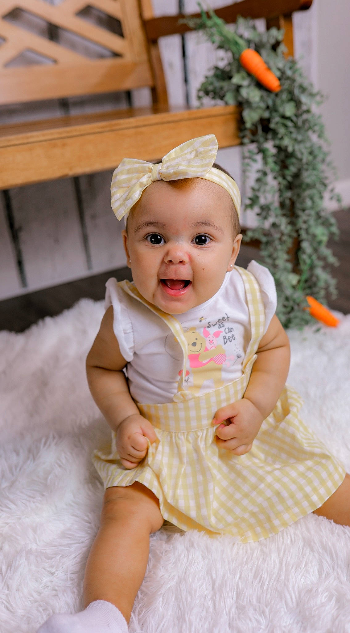 Harmony is registered to the contest to win money with this photo: baby, baby_toddler_clothing, child, clothing, fashion_accessory, fun, happy, hat, headband, headgear, pattern, person, pink, sitting, skin, sleeve, smile, table, toddler, white