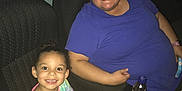 Isabella is registered to the contest to win money with this photo: child, adult, popcorn, drink, movie_theater, seat, glasses, smile, colorful_clothing, purple_shirt, happy, indoor, food, snack, person, leisure, family, together, entertainment, fun