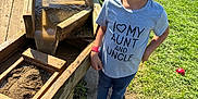 Isabella joined the competition — help win amazing prizes! child, smiling, outdoor, grass, wood, water, play, sunlight, casual_clothing, tshirt, blue_pants, shoes, sand, wooden_structure, happy, person, daylight, nature, fun, playground