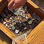 Isabella joined the competition — help win amazing prizes! child, hand, stones, gravel, wood, sieve, small_rocks, colorful, outdoor, sunlight, play, exploration, nature, texture, close_up, activity, water, plastic_bag, natural_light, hobby