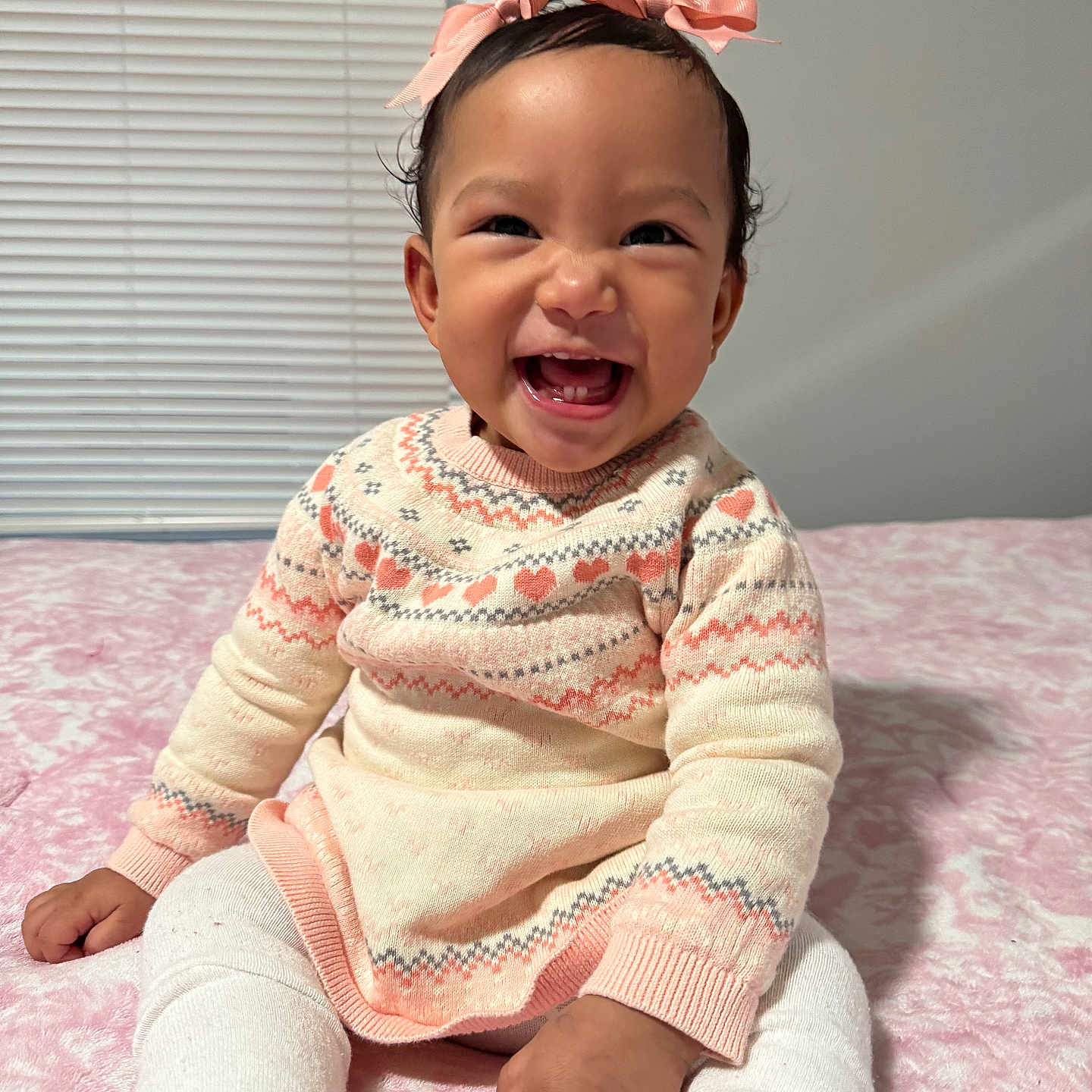 Alessia Alanna is registered to the contest to win money with this photo: baby, black_shoes, blanket, bow, child, cozy, cute, face, hands, happy, headband, indoors, infant, patterned_clothing, pink, portrait, sitting, smiling, sweater, white_tights