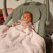 Layla-Rae is registered to the contest to win money with this photo: baby, blanket, baby_rocker, plush_toys, bunny, pink, gray, infant, child, face, soft, cushion, nursery, indoor, person, cute, sleeping_area, clothing, toy, comfort