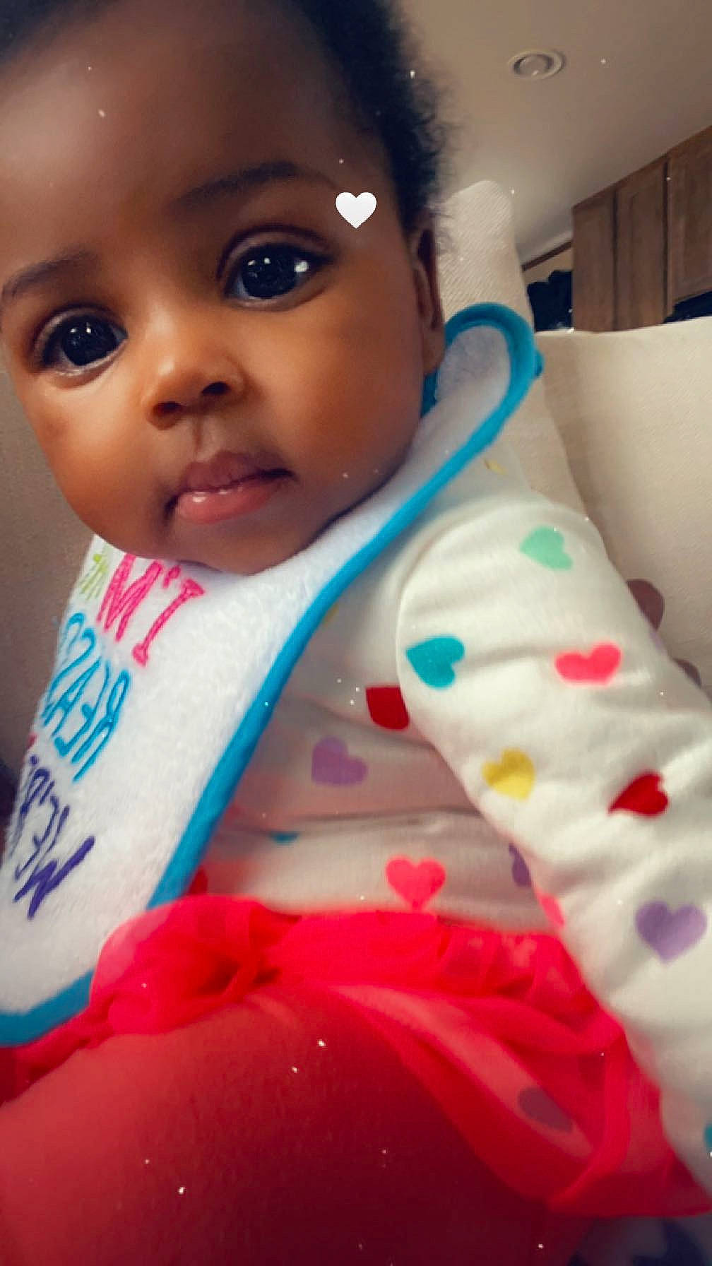 Lailah is registered to the contest to win money with this photo: arm, baby, baby_toddler_clothing, cheek, dress, eye, eyebrow, eyelash, face, happy, head, human_body, iris, lip, mouth, nose, person, pink, skin, sleeve