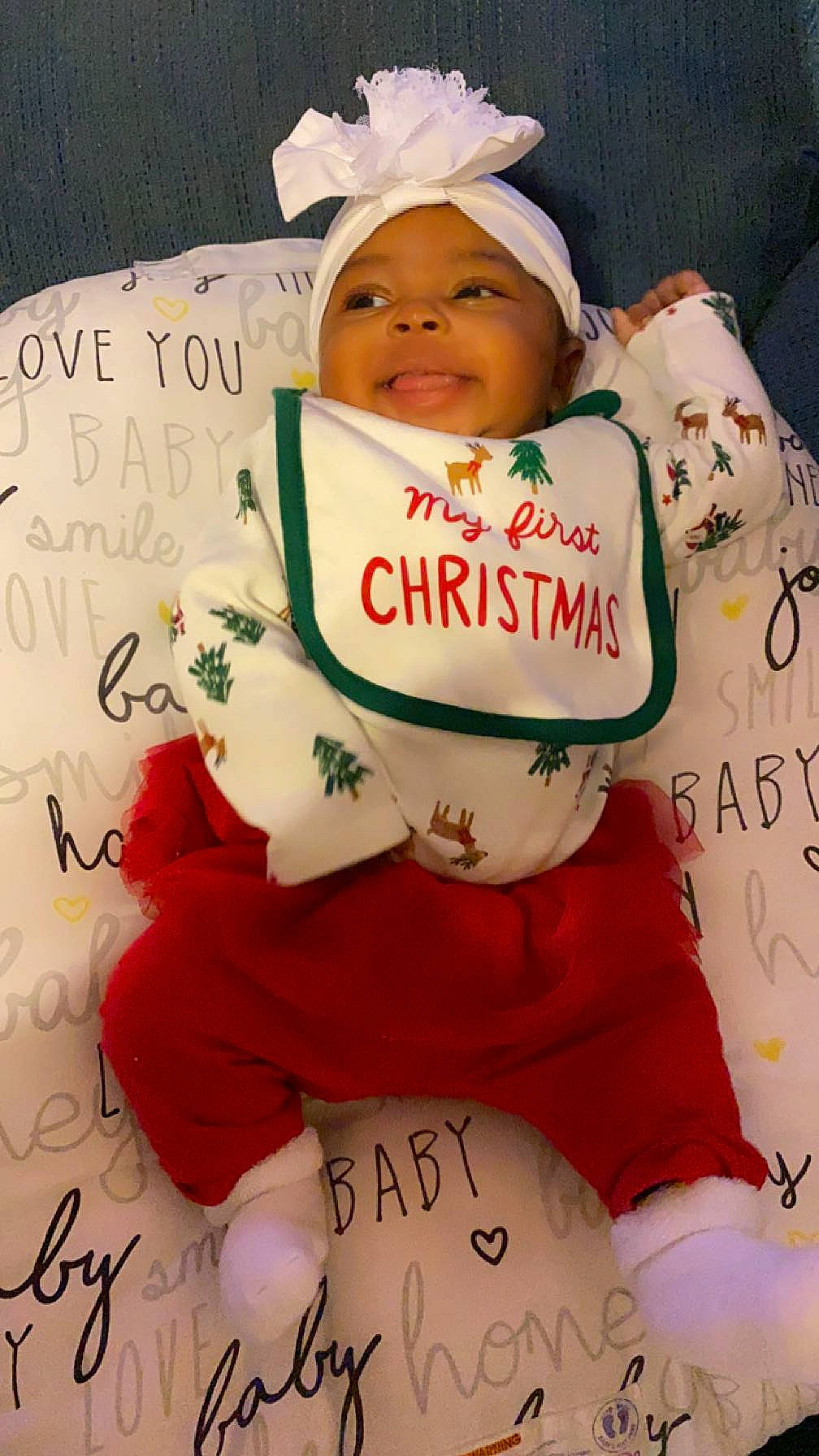 Lailah is registered to the contest to win money with this photo: baby, baby_toddler_clothing, carmine, child, christmas, christmas_eve, event, fictional_character, font, handwriting, happy, headwear, holiday, person, pink, smile, sock, sugar_cake, sweetness, toddler