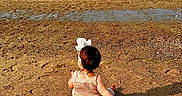 Mary is registered to the contest to win money with this photo: toddler, beach, sand, sea, water, sky, child, bow, toy, milestone, writing, outdoor, sunlight, summer, baby, nature, shore, vacation, relaxation, play