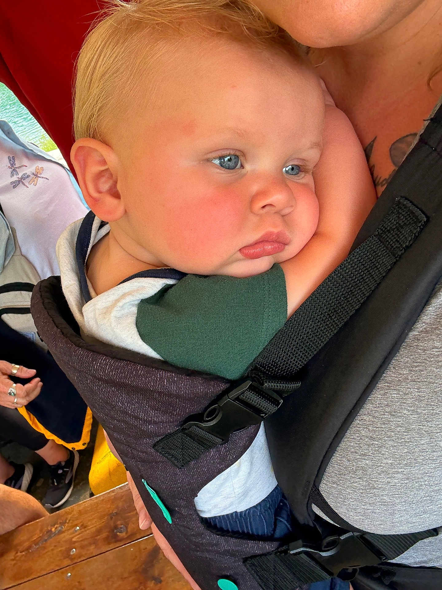 Bodie joined the competition — help win amazing prizes! baby, child, blue_eyes, baby_carrier, close_up, face, person, adult, holding, casual_clothing, indoor, wooden_surface, comfort, snug, resting, cute, skin, hair, expression, human