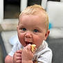 Bodie is registered to the contest to win money with this photo: baby, child, blue_eyes, blond_hair, eating, food, hand, mouth_open, person, portrait, close_up, cute, indoor, white_shirt, skin, happy, holding, infant, young_child, focus
